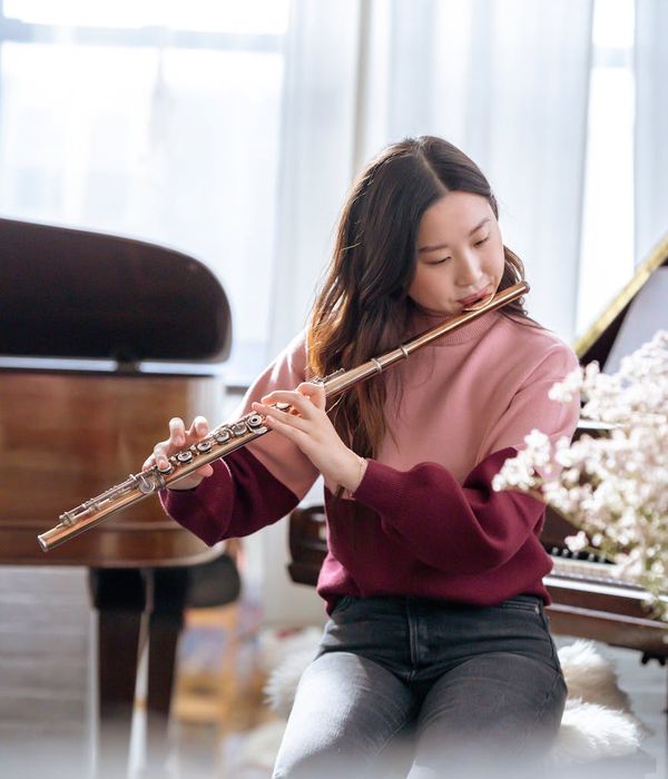 Woman feeling serene and energetic in a bright, sunlit room.